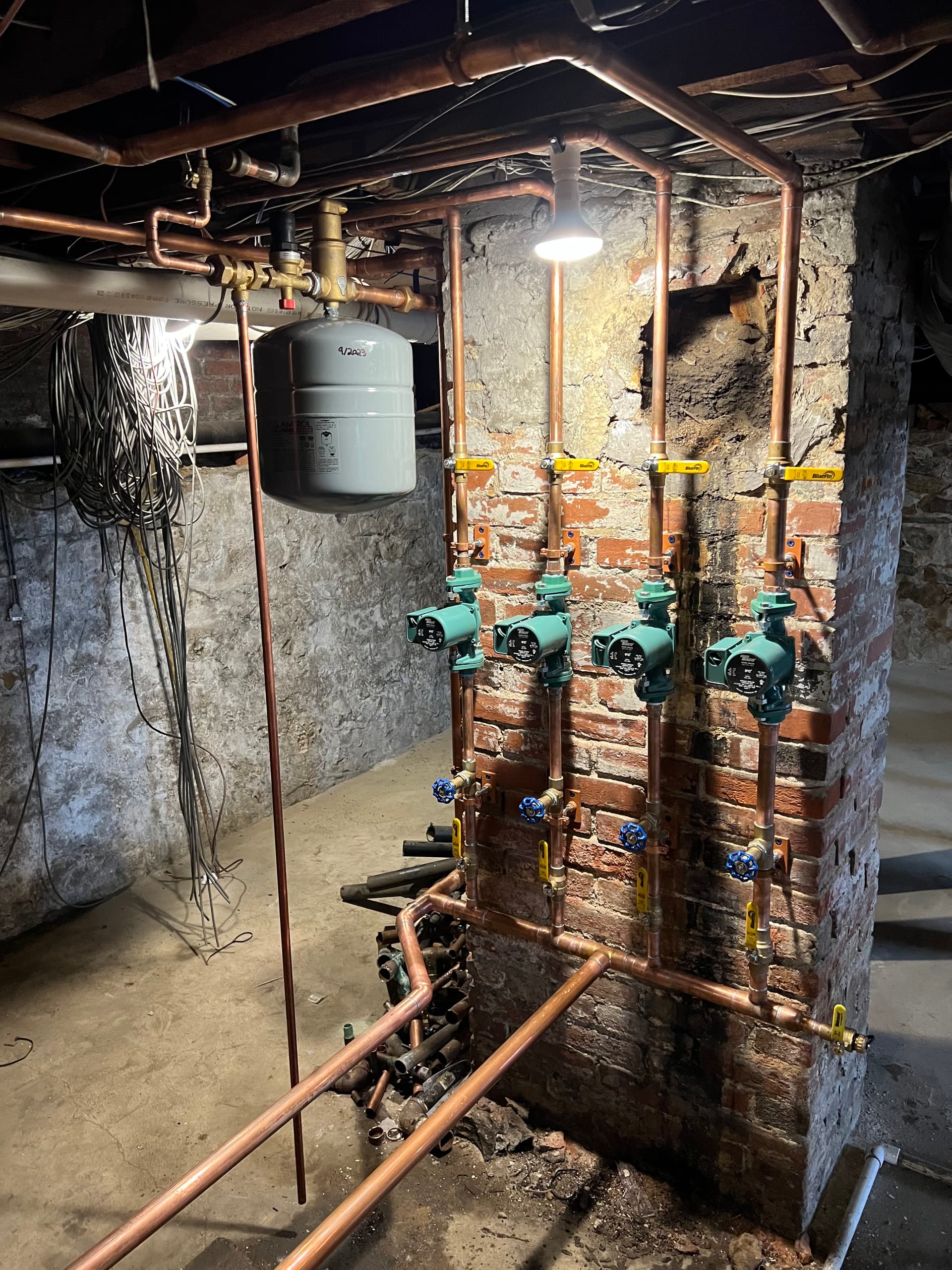 Copper pipe radiant heating system with circulators installed by Milloway Pipeworks